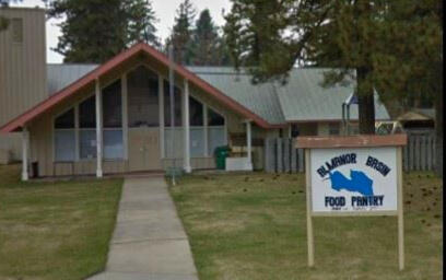 Lake Almanor basin food pantry volunteers three lake almanor basin food pantry volunteers assembled outside a distribuition point with a truck and camper shell, outdoors.
